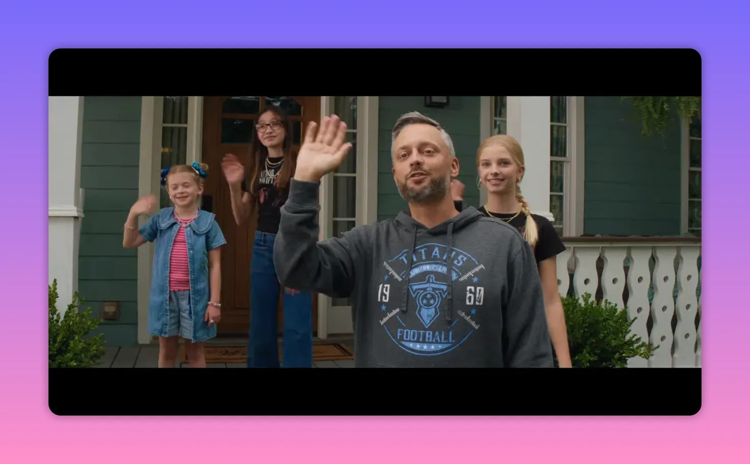 Close view of Nate waving from the porch with his three daughters smiling behind him