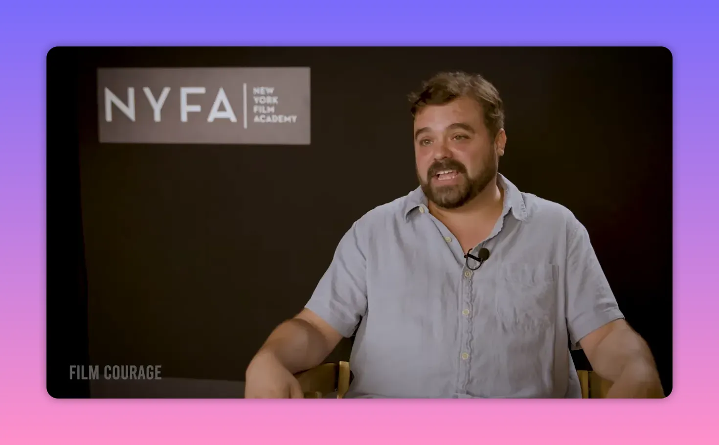 Interviewee smiling and speaking warmly in front of NYFA (New York Film Academy) backdrop