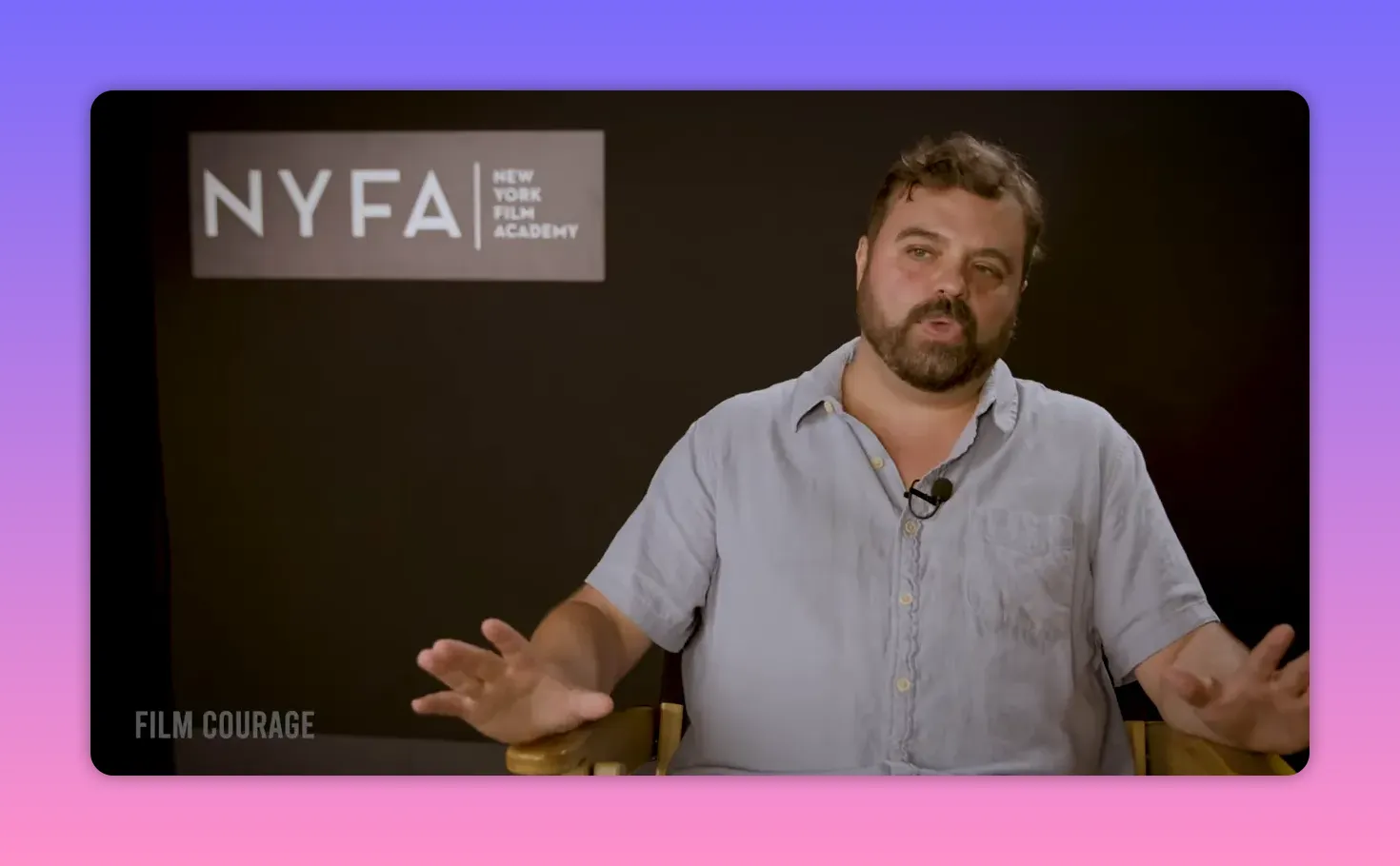 Interviewee with open palms in a giving gesture while speaking, NYFA backdrop behind