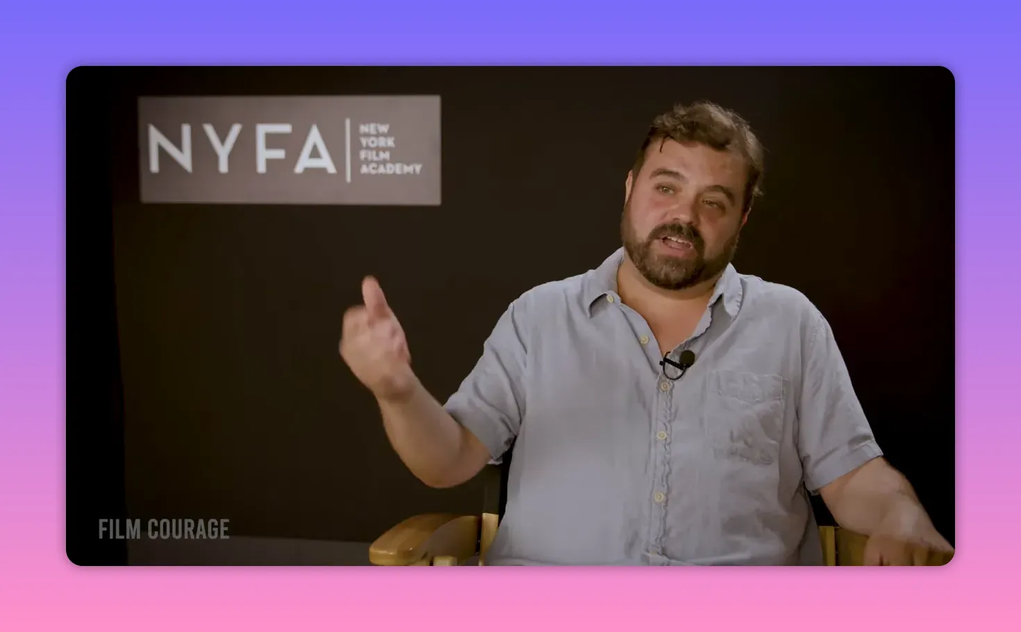 Interviewee gesturing with an open hand while speaking in front of a NYFA backdrop