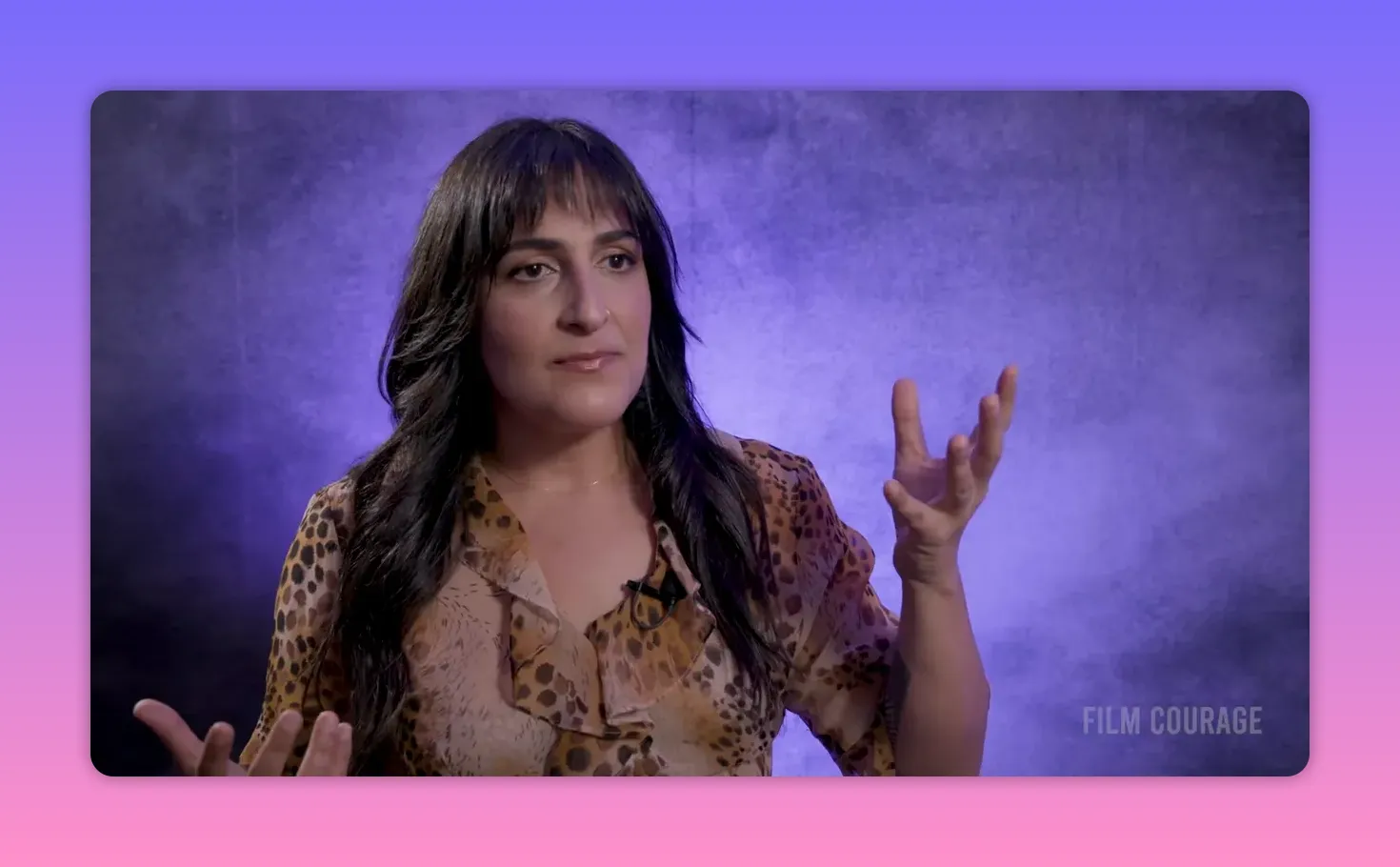 interview subject gesturing while explaining mental resistance against a purple backdrop