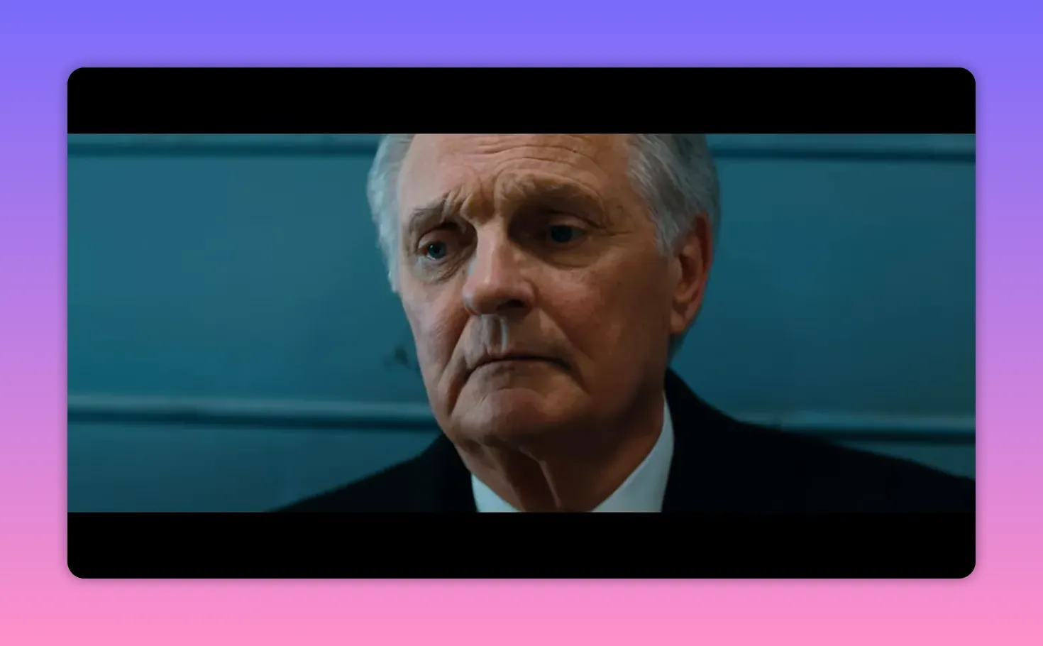 older man in a suit looking thoughtful and composed, upper body visible