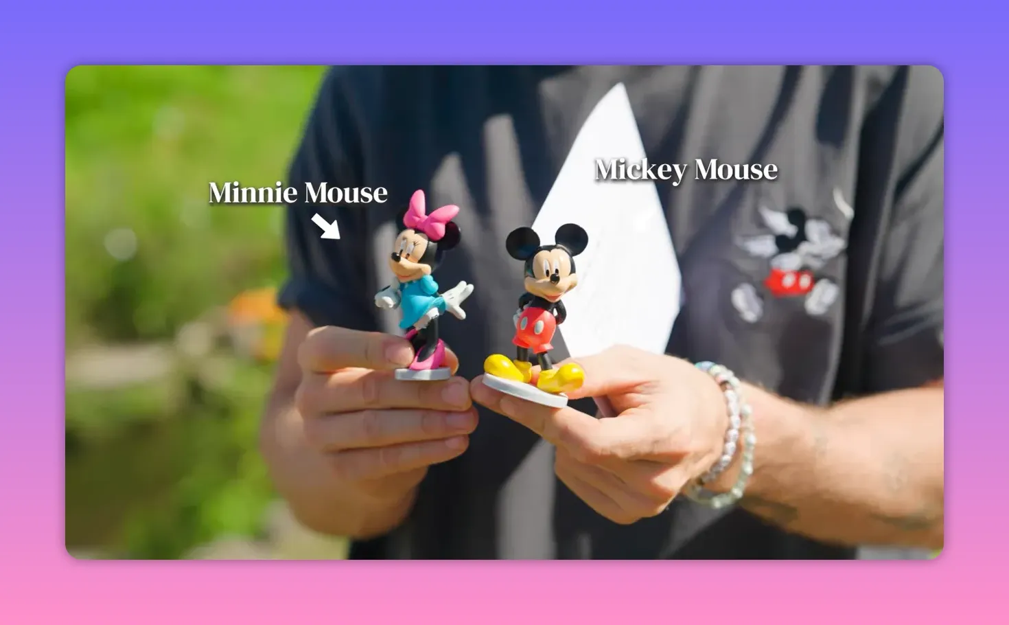 Close-up of Minnie Mouse and Mickey Mouse figurines held in hands