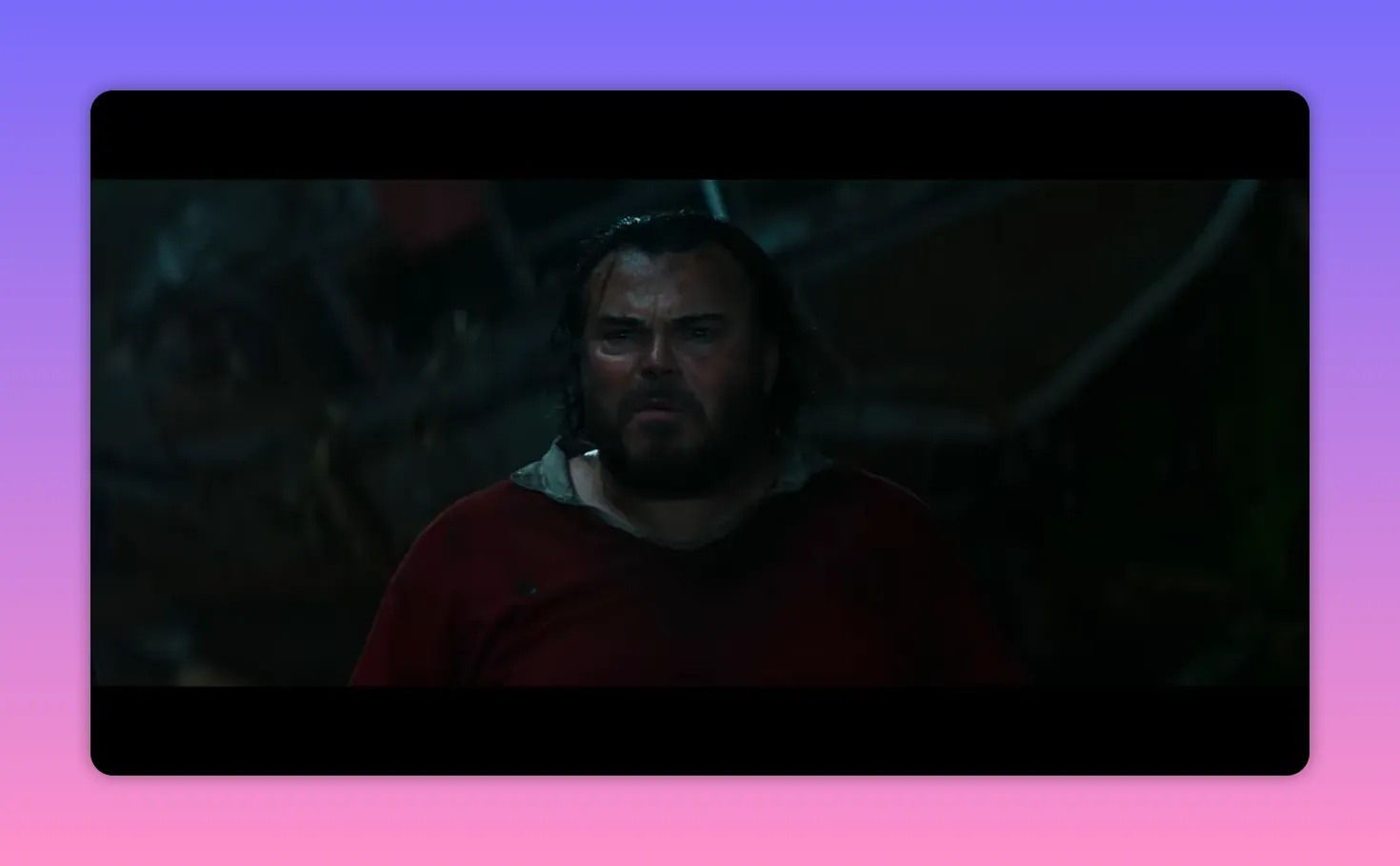 close-up of a wet, bearded man looking shocked and determined in dim light