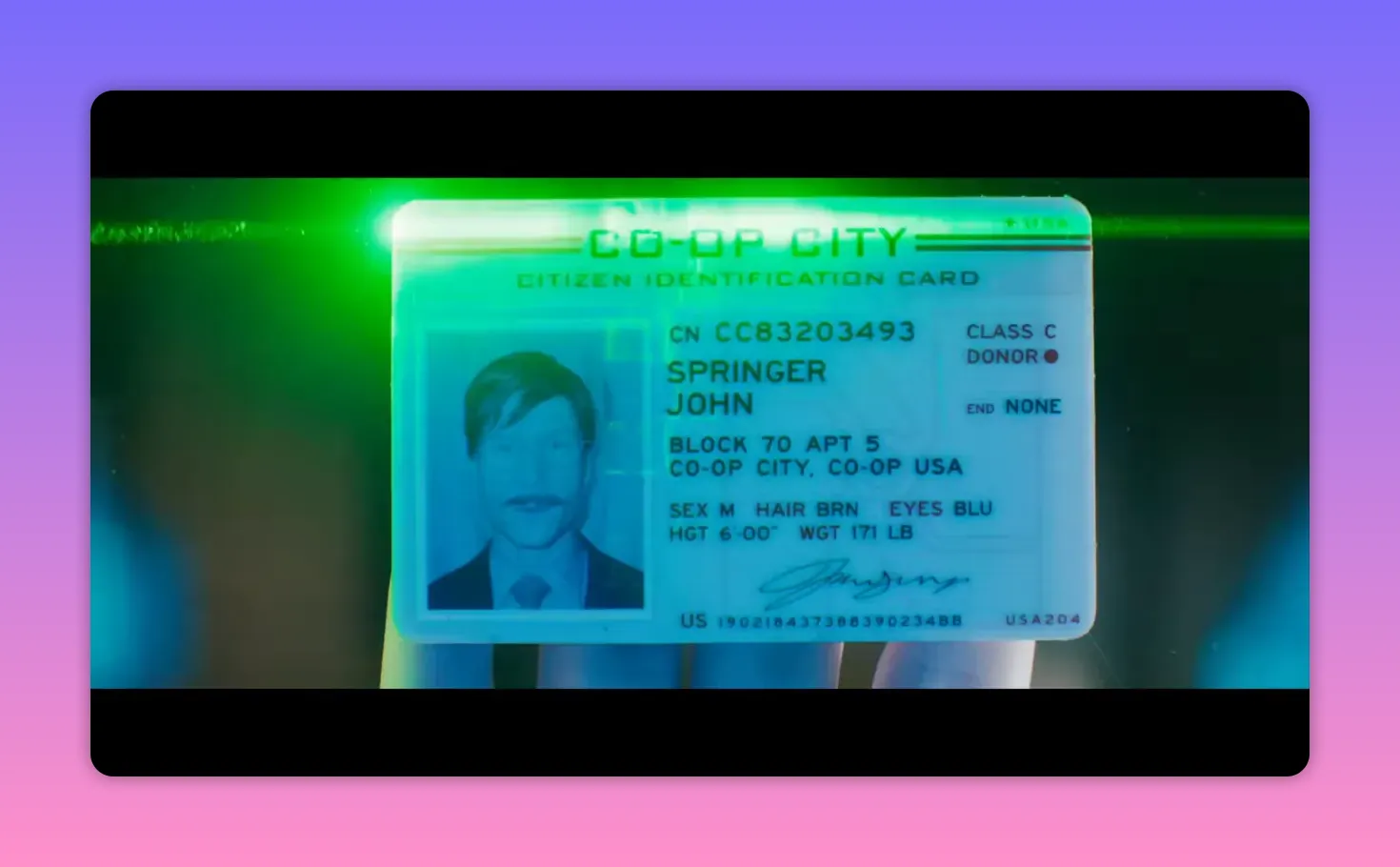 Close-up of a glowing citizen identification card showing name, photo and city details