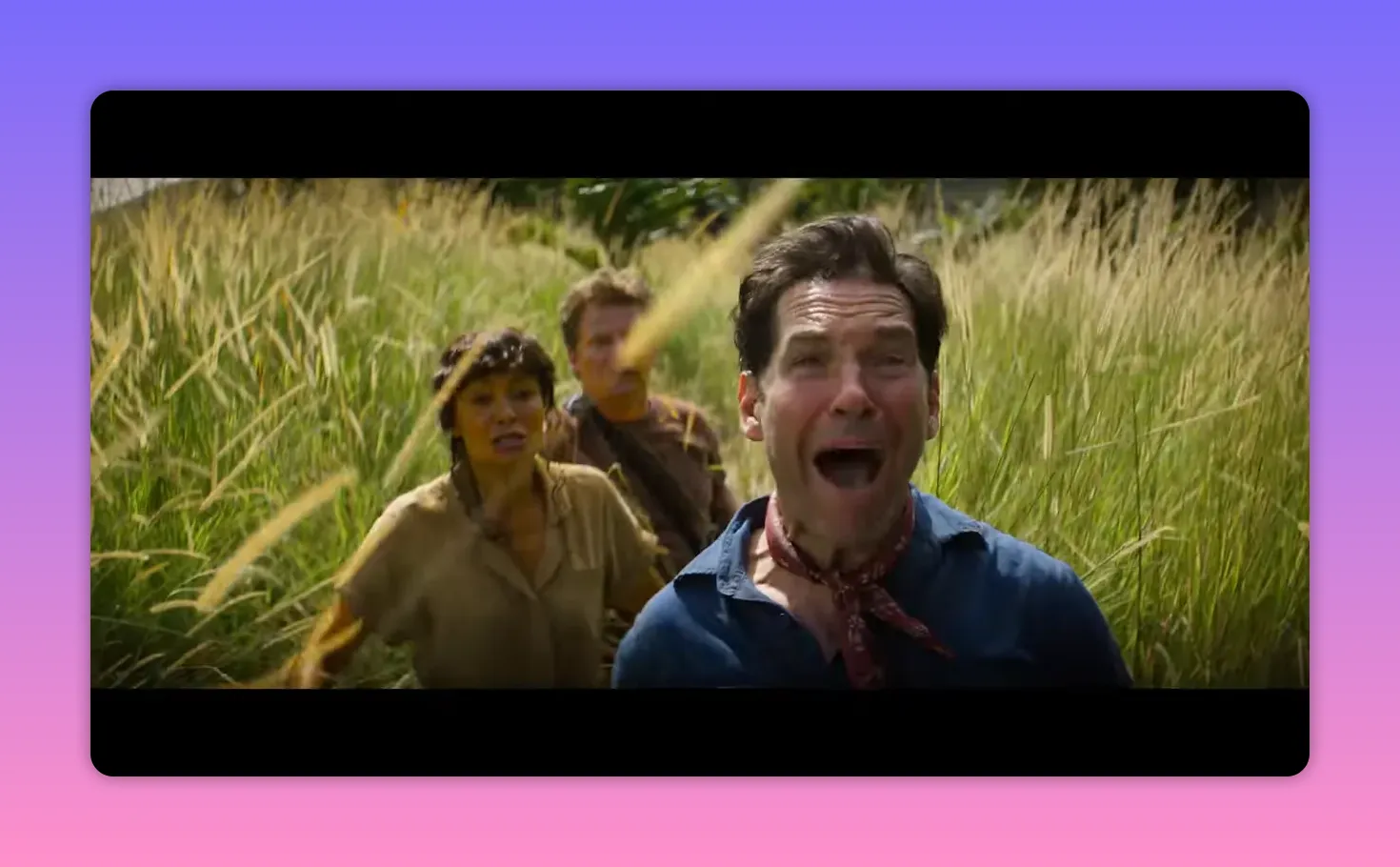 three people running through tall grass with the lead man screaming in alarm