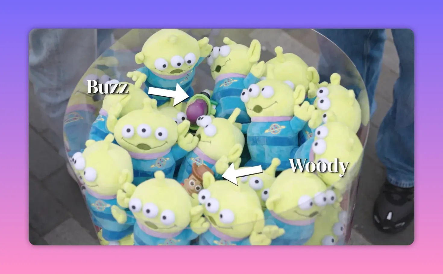 Top view inside the prize capsule with Buzz and Woody toys highlighted among green alien plushies