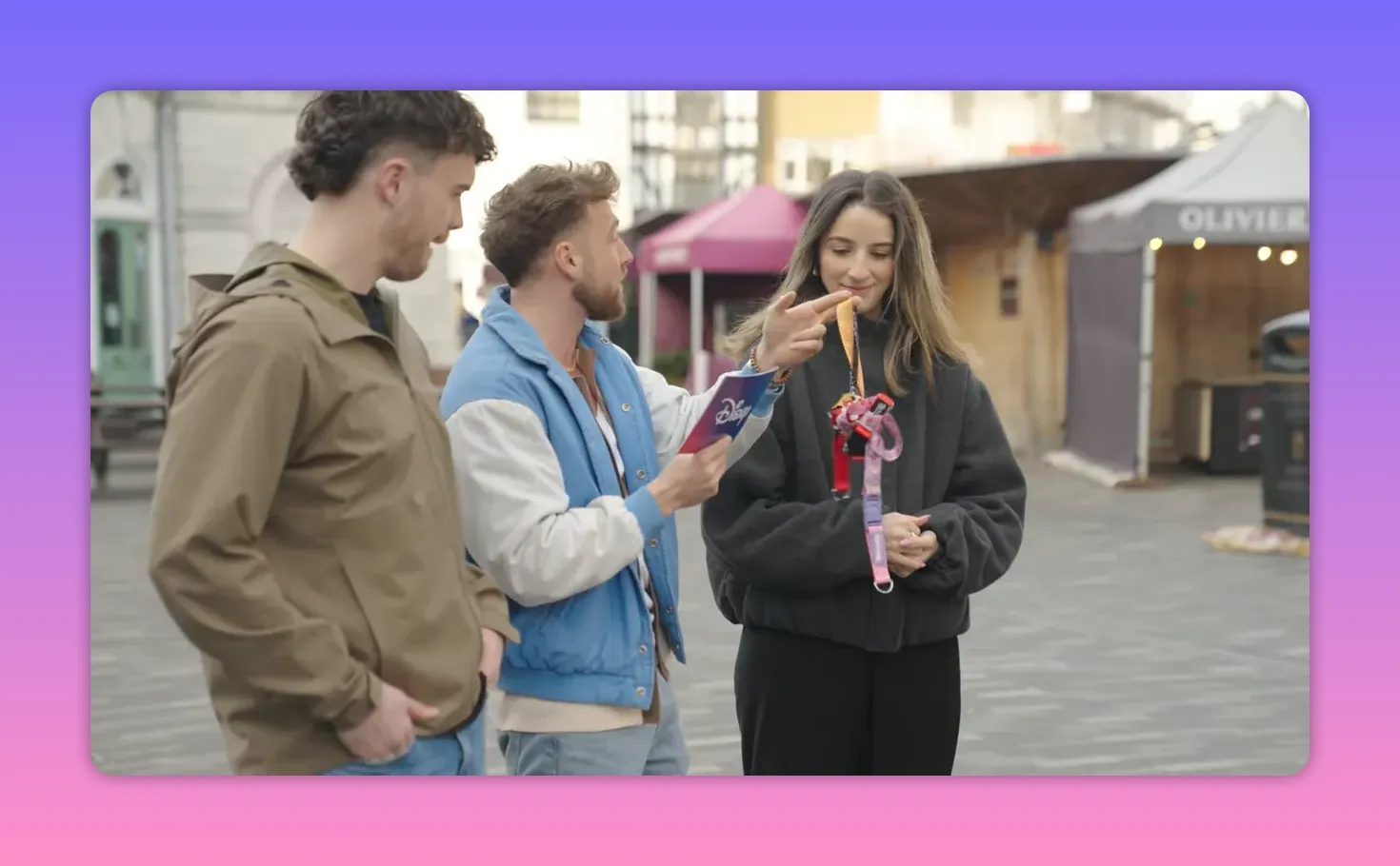 Host pointing to the ends of a cluster of Disney lanyards as a contestant smiles, ready to untangle