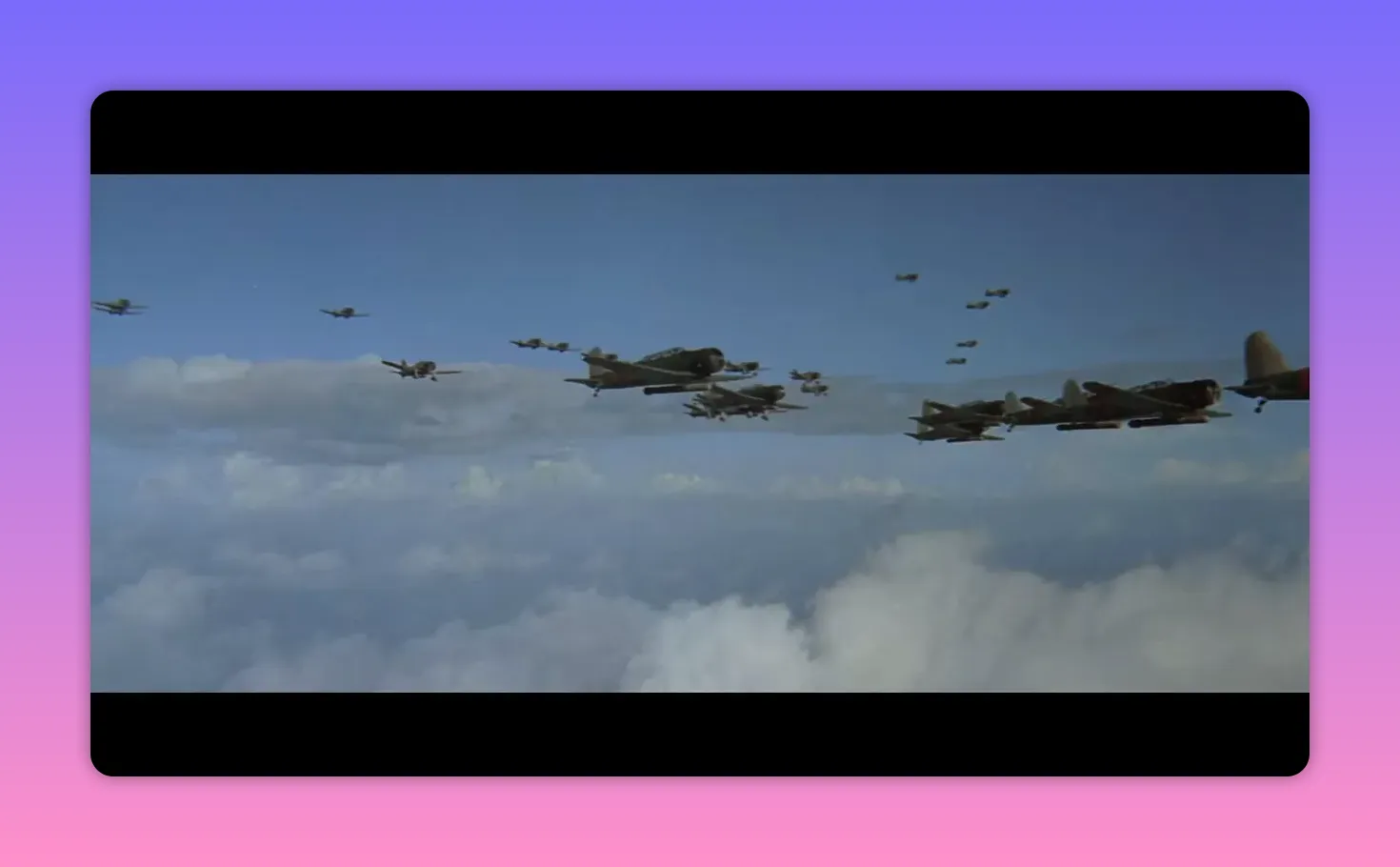 Multiple military aircraft flying in formation above the clouds