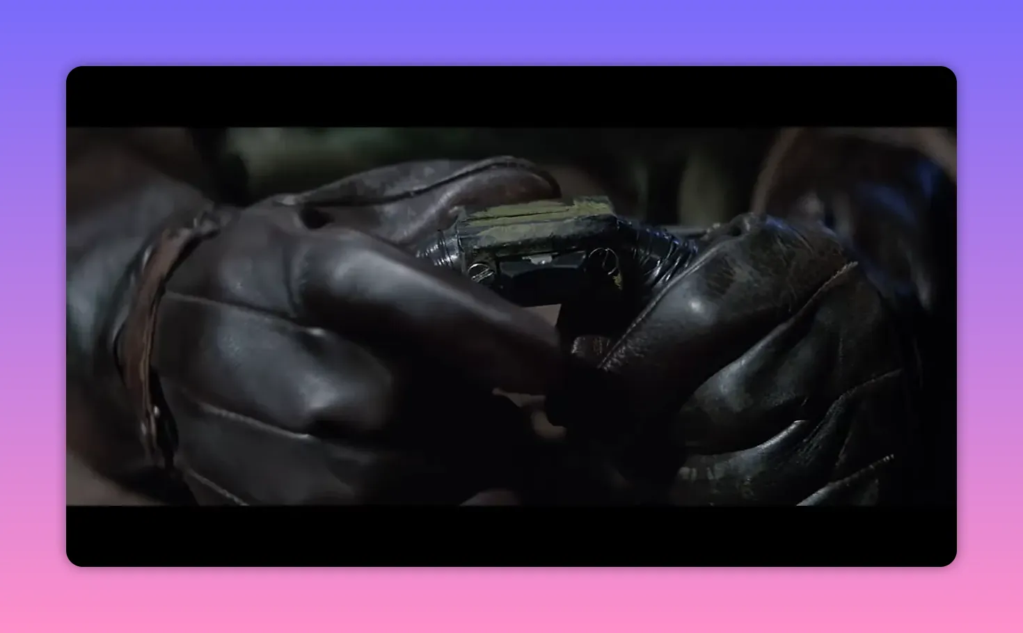 Close-up of leather-gloved hands holding and checking a small instrument or device