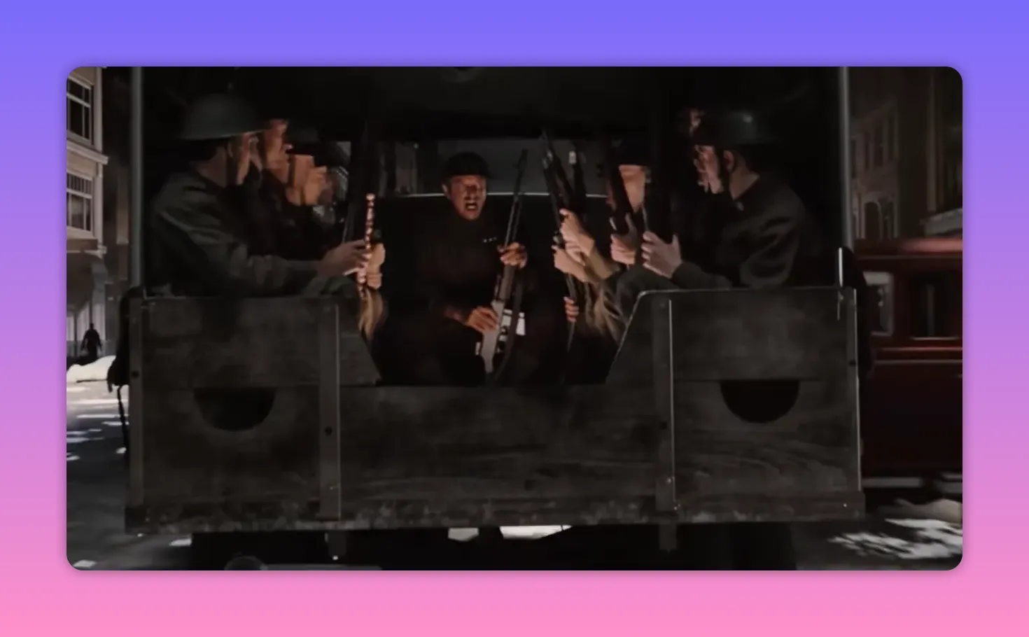 Wide shot of armed men seated in the back of a military truck on a snowy city street at night