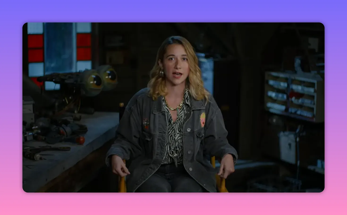 Seated costumer in a workshop interview, speaking to camera with tools and workbench in the background.