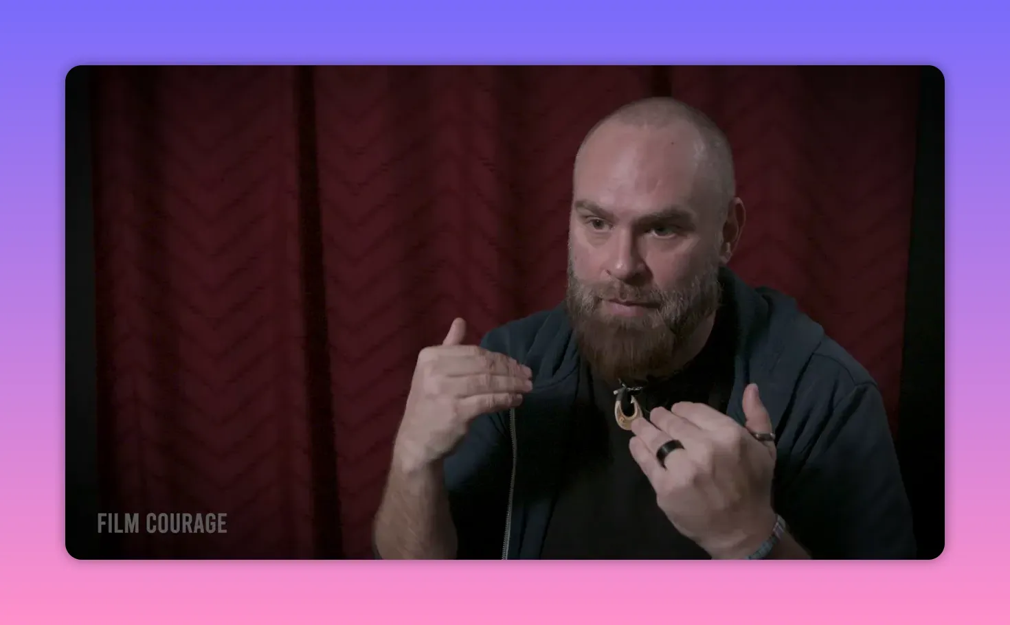 Interview subject using two hands to gesture while explaining a concept, clear face