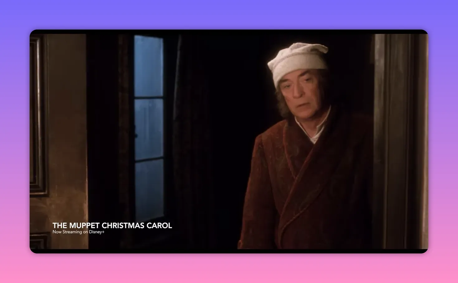Scrooge standing in a doorway wearing a nightcap and robe, looking somber
