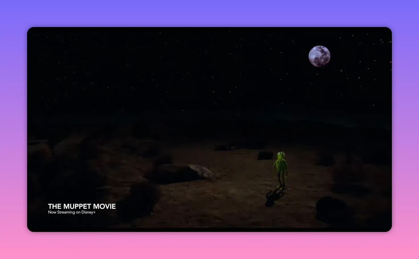 Wide, cinematic shot of Kermit the Frog standing alone under a star-filled sky with a visible moon, from The Muppet Movie.