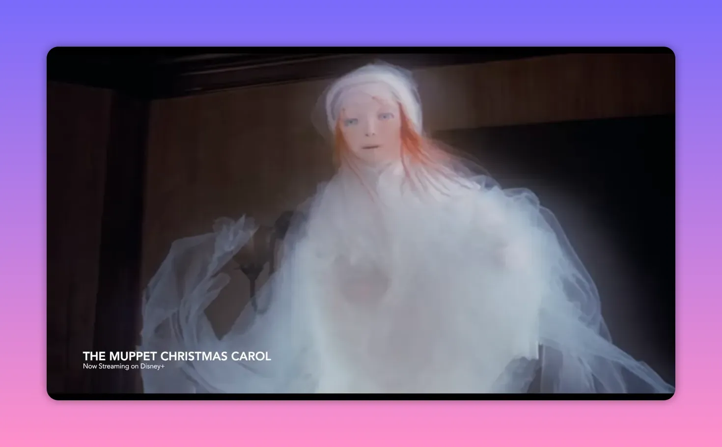 Close-up of the Ghost of Christmas Past puppet: pale face, red hair, and swirling translucent fabric creating a dreamlike, submerged look.