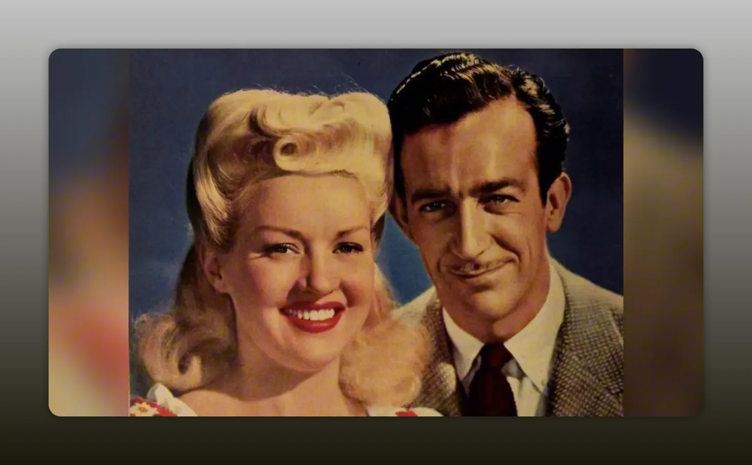 High-quality vintage studio portrait showing a smiling blonde actress beside a man in a suit