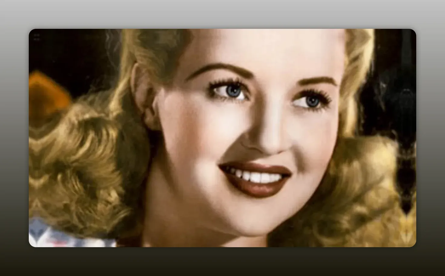 High-quality colorized studio portrait of a 1940s film actress smiling, well-lit and in focus