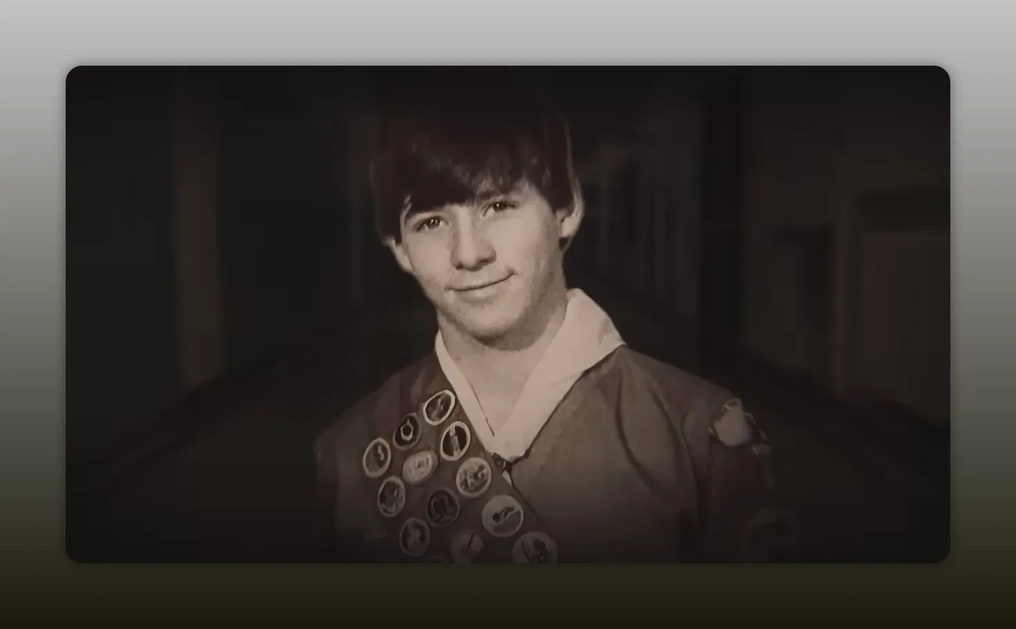 young man in Boy Scout uniform with merit badge sash, centered and clear