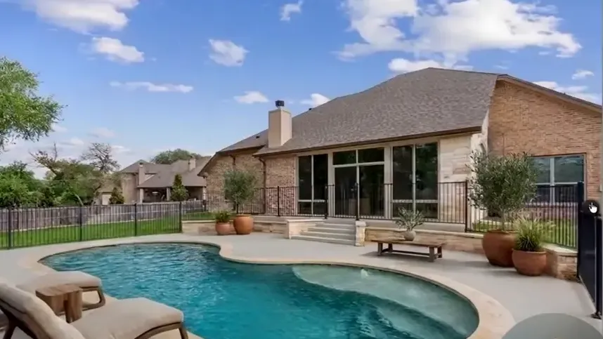 Backyard pool with curved edge and covered patio in Rancho Del Lago