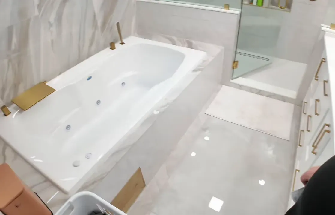 Master bathroom with jetted bathtub and tiled shower in a Summerville home
