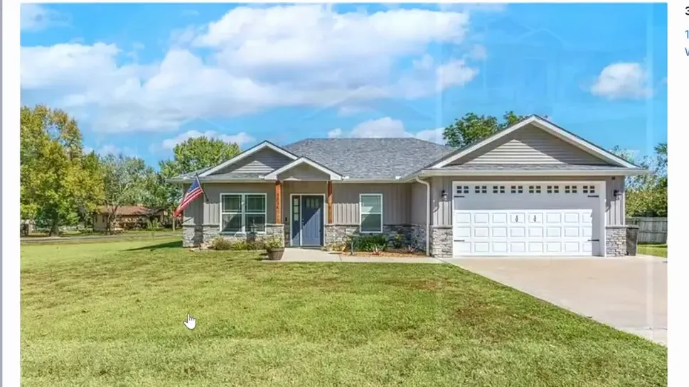 Modern single story home with a large lawn and two car garage