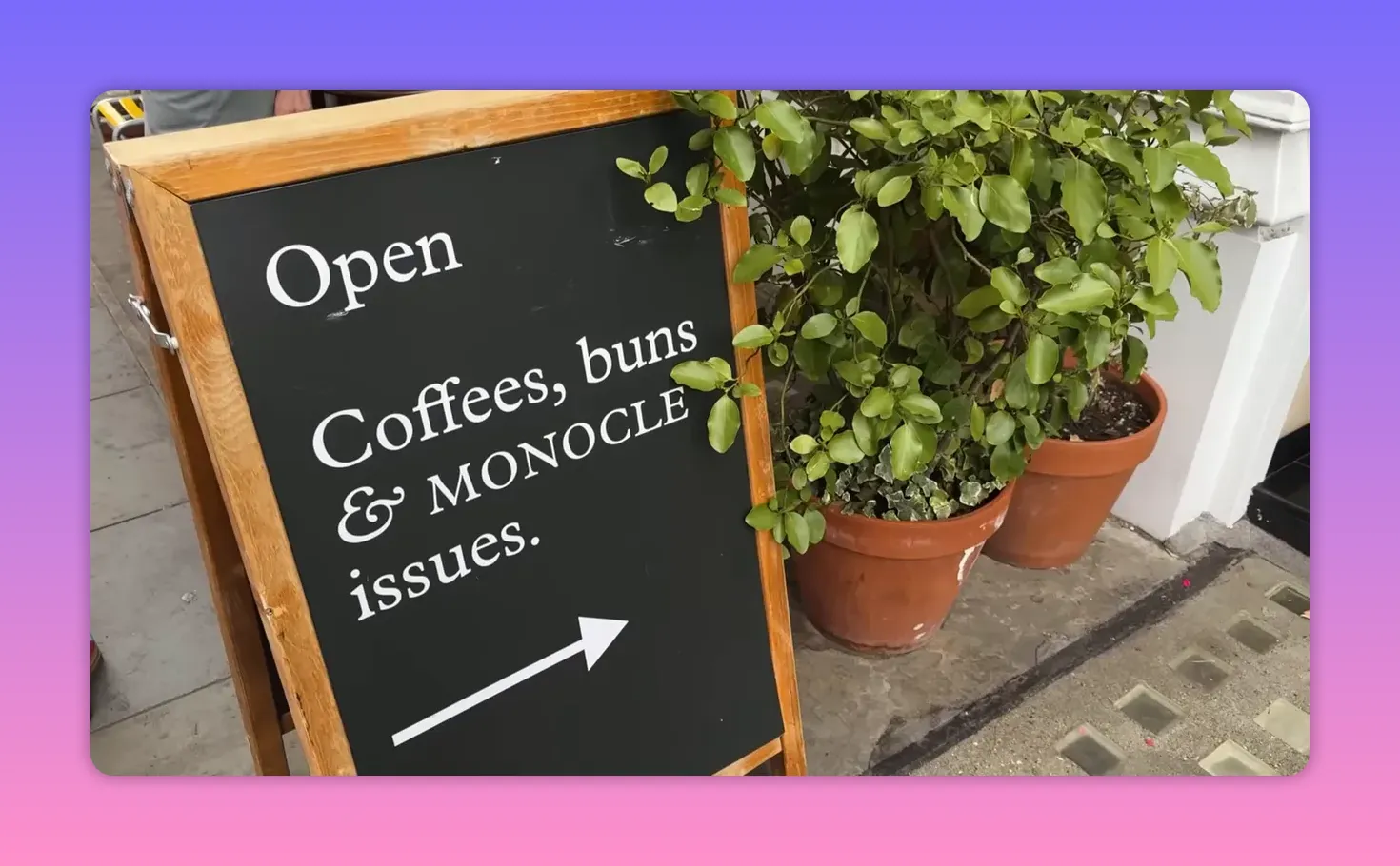 Chalkboard sign outside a shop advertising coffees, buns, and Monocle in Marylebone
