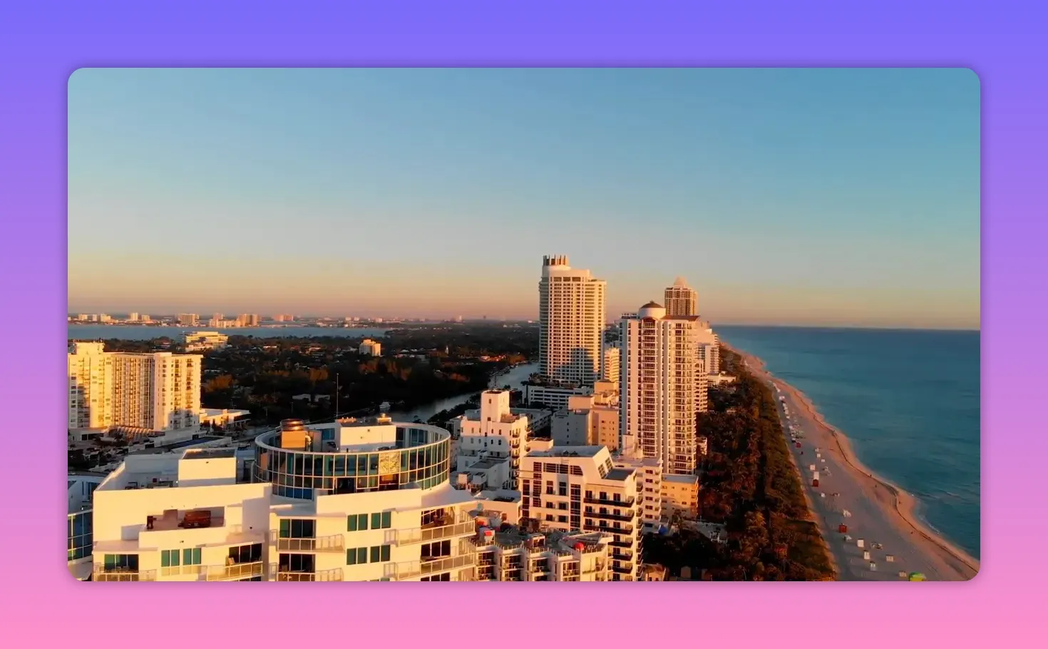 Aerial view of Miami beachfront buildings and skyline at sunset
