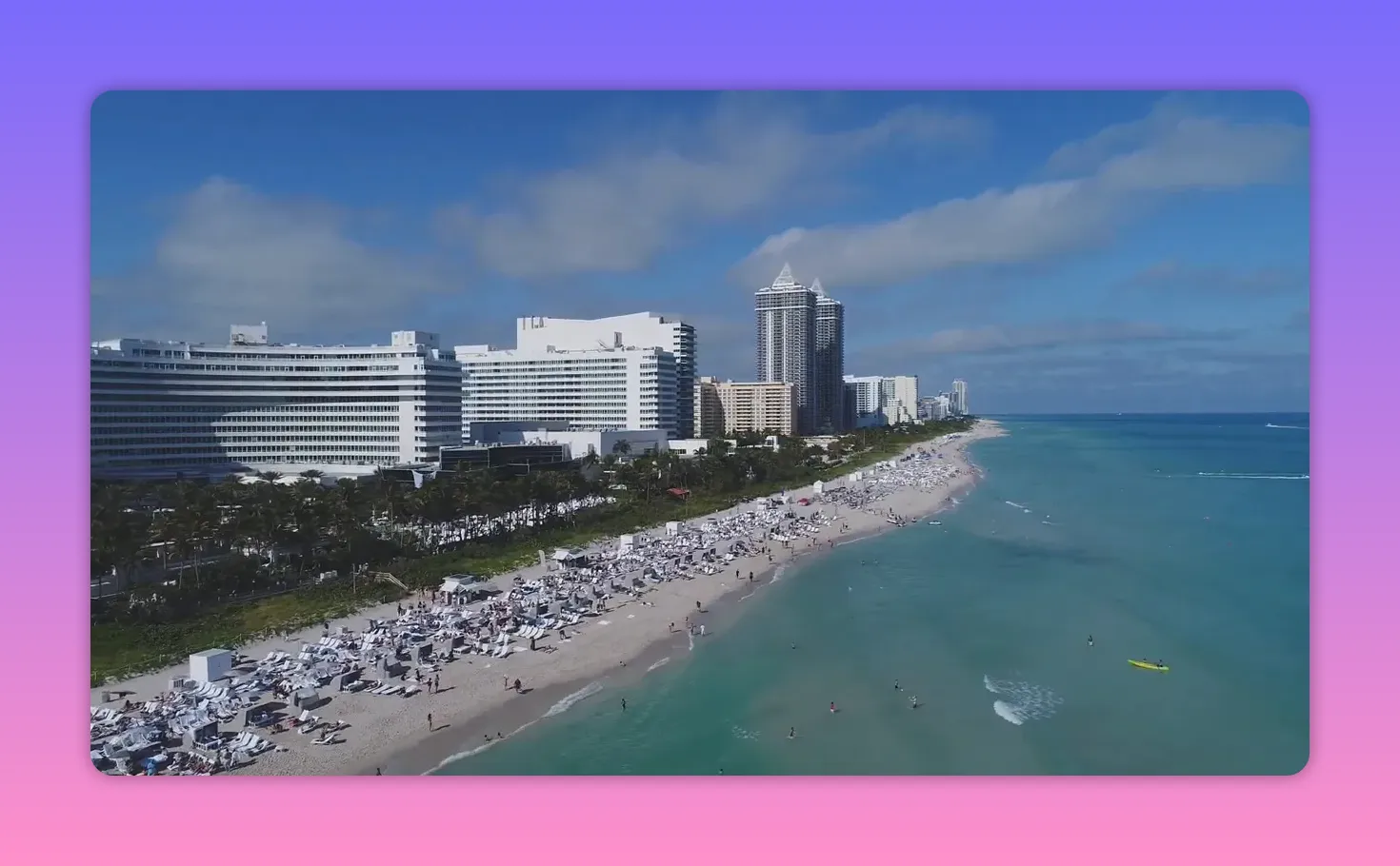 Aerial view of Miami Beach with a long sandy shoreline, ocean water, and waterfront hotels
