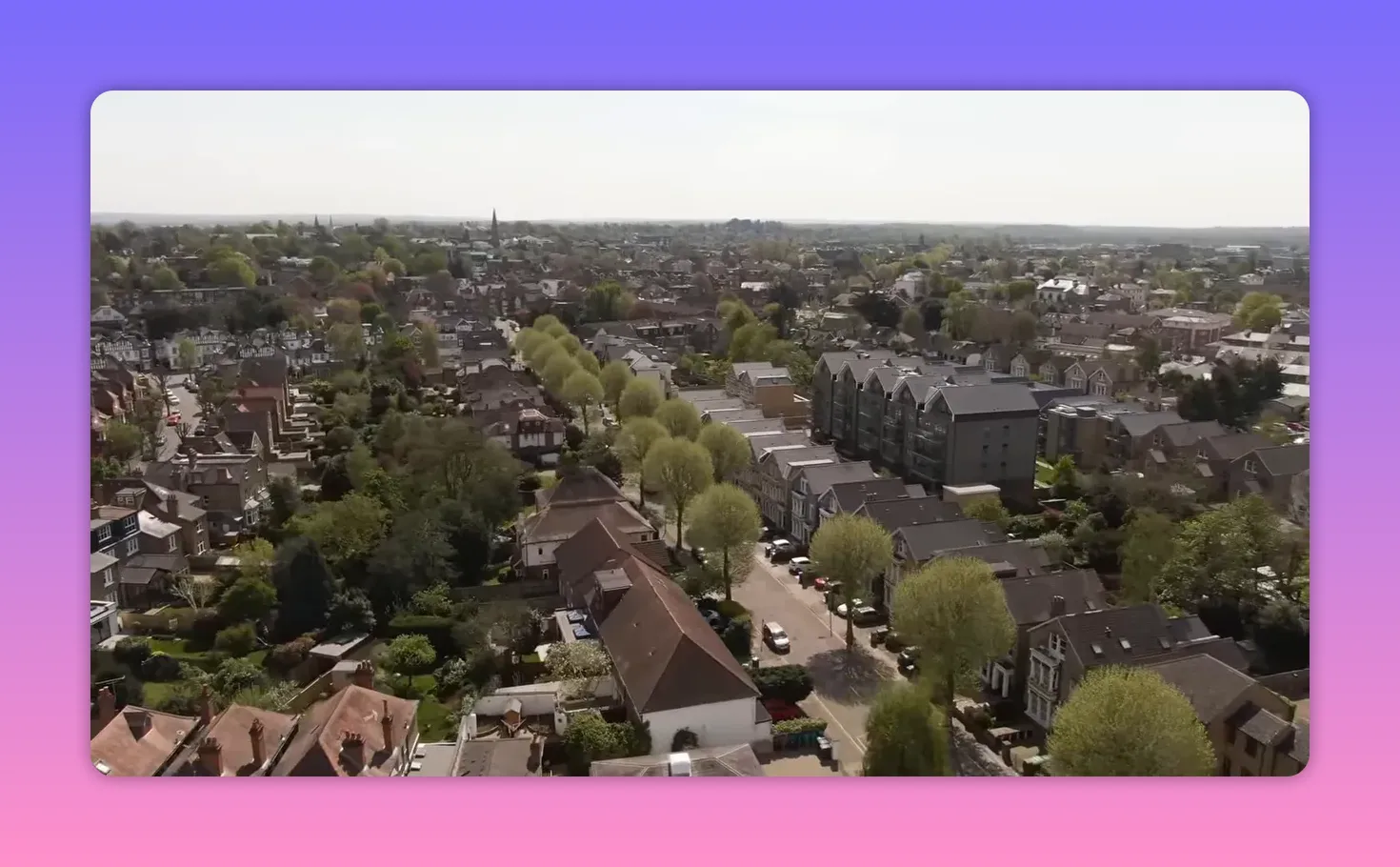 Clear aerial view of residential rooftops, streets, and apartment buildings
