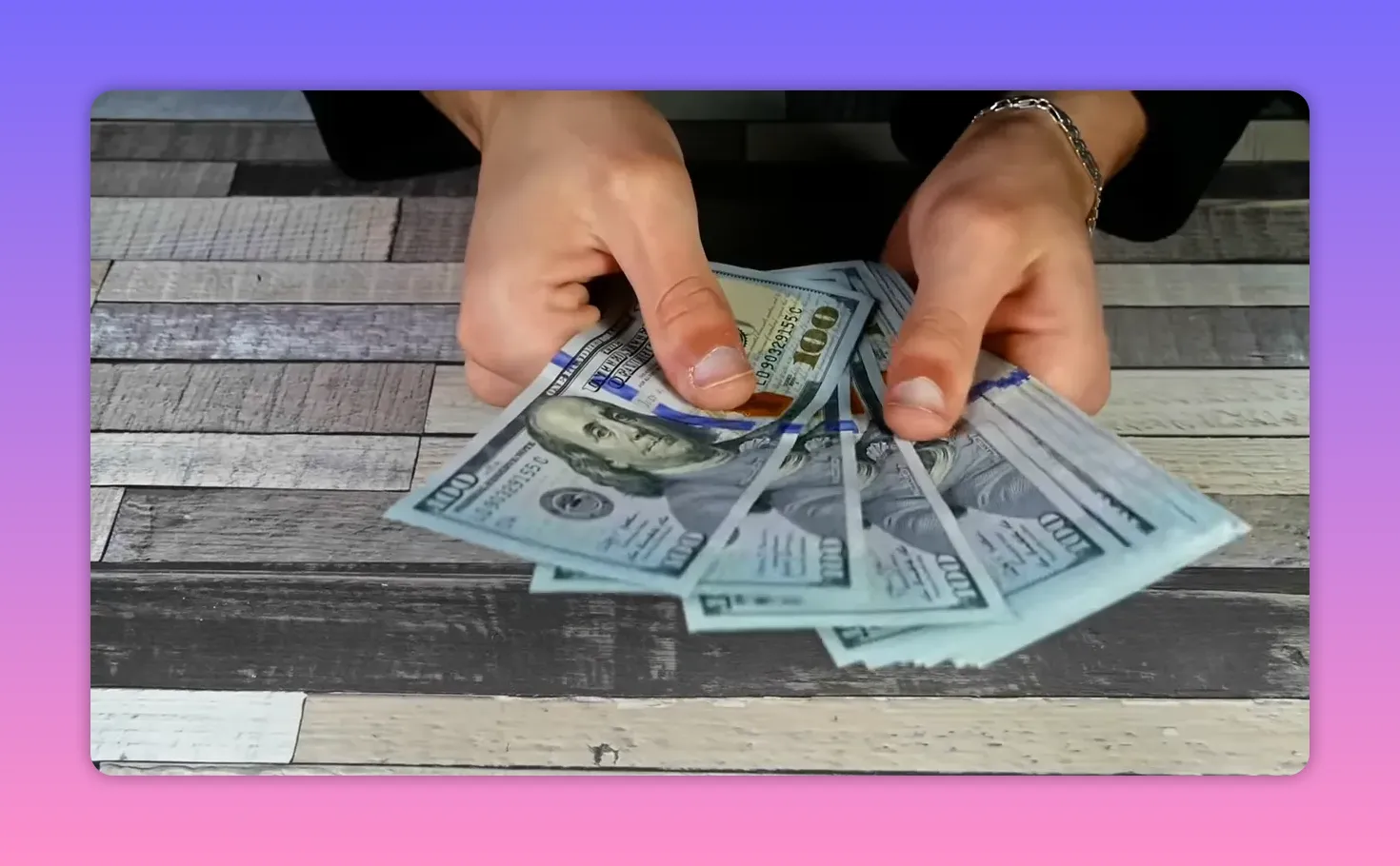 Hands counting banknotes on a table outdoors