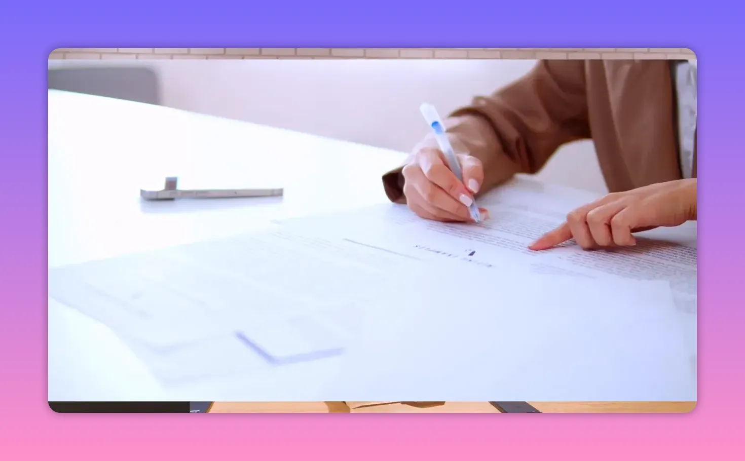 Hands reviewing and signing property paperwork during a real estate transaction