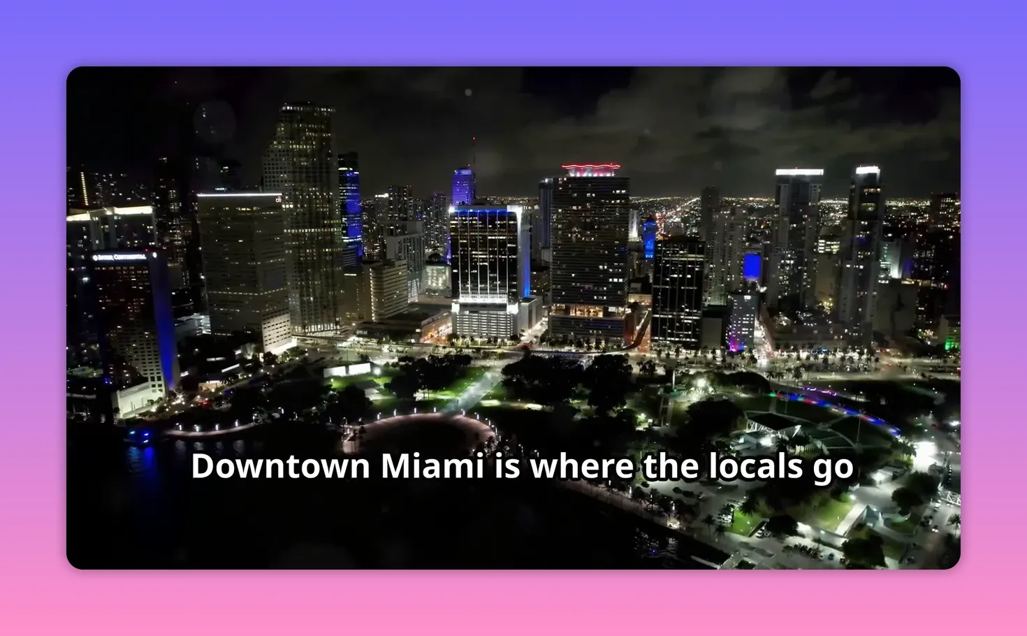 Aerial view of Downtown Miami at night with illuminated buildings and streets