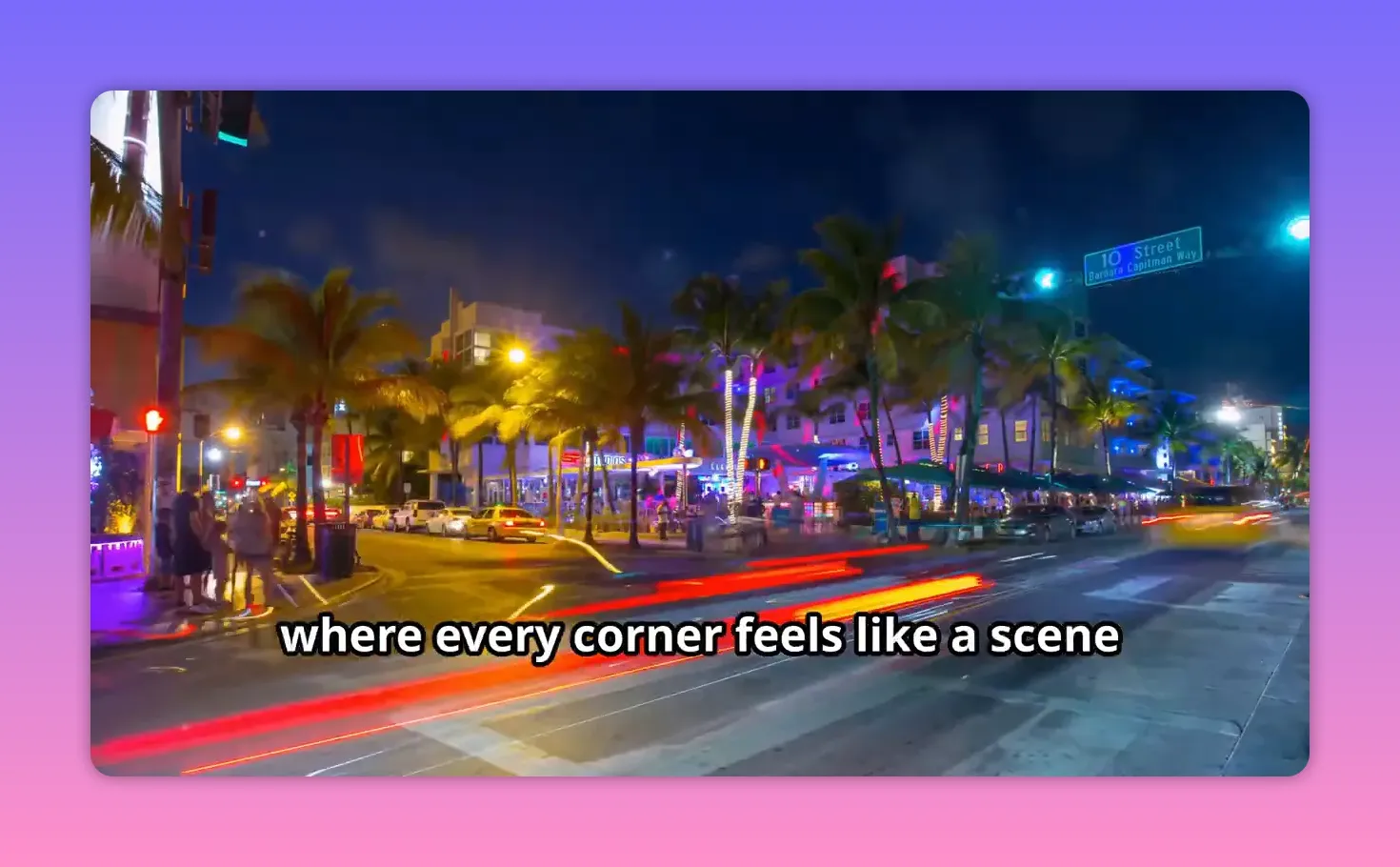 Neon street scene in South Beach at night with palm trees and moving car lights