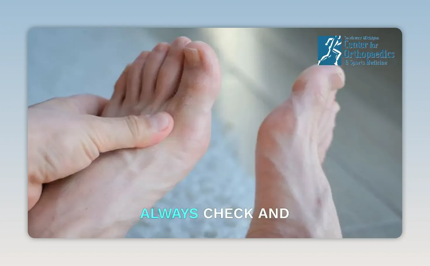 Hands examining the top of a bare foot
