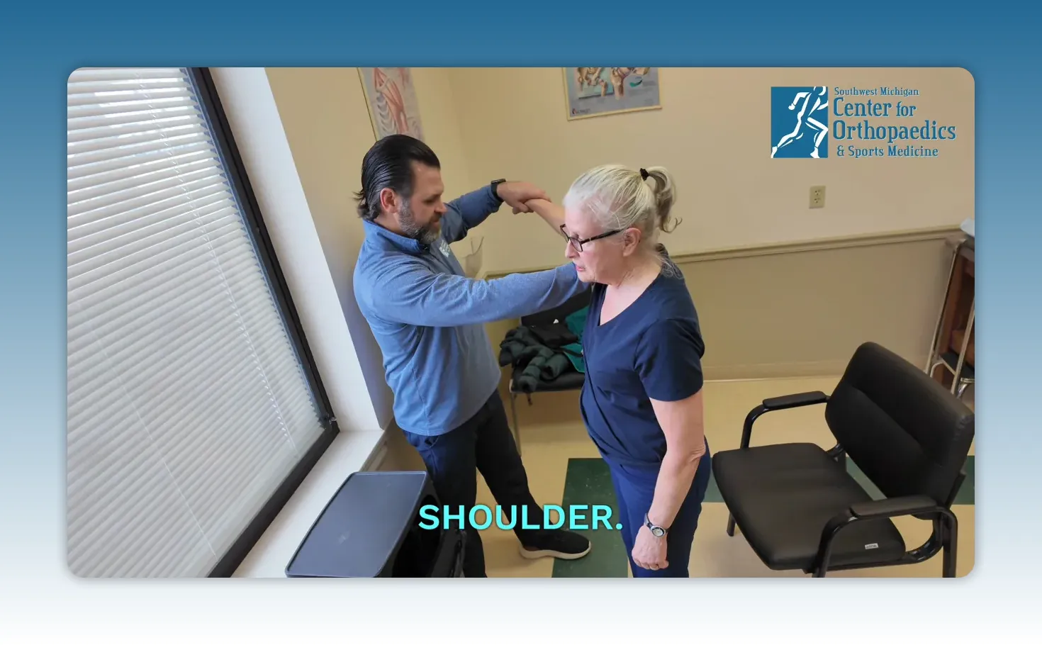 Overhead view of clinician assessing a patient's shoulder in clinic