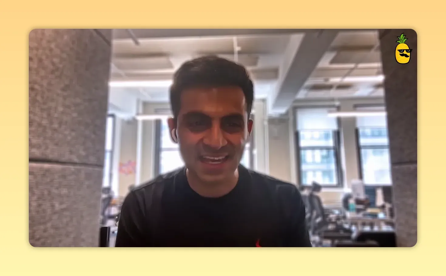 Founder addressing the camera from an office booth with a clear view of the workspace behind him.