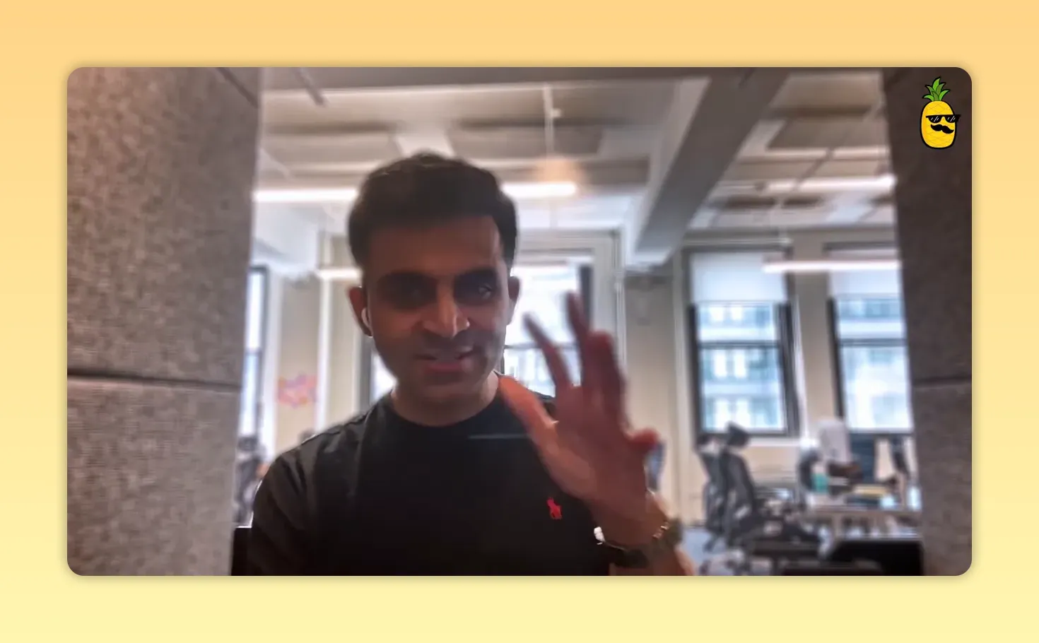Founder making a hand gesture in an office, emphasizing a point during an interview