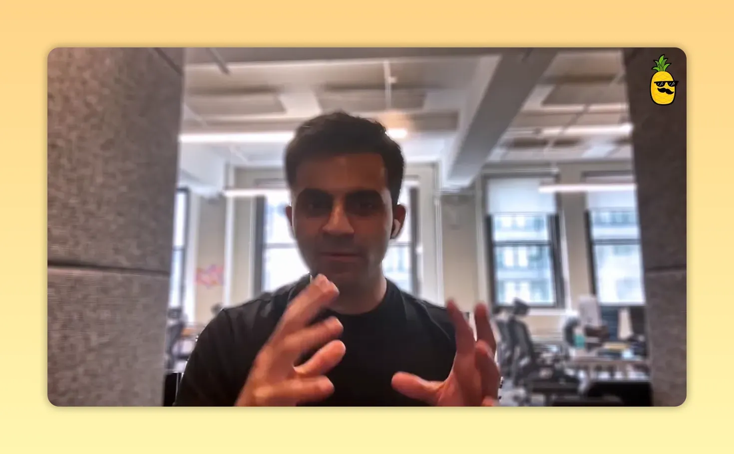 Founder gesturing with both hands while explaining AI-driven operational and hiring changes in an office setting