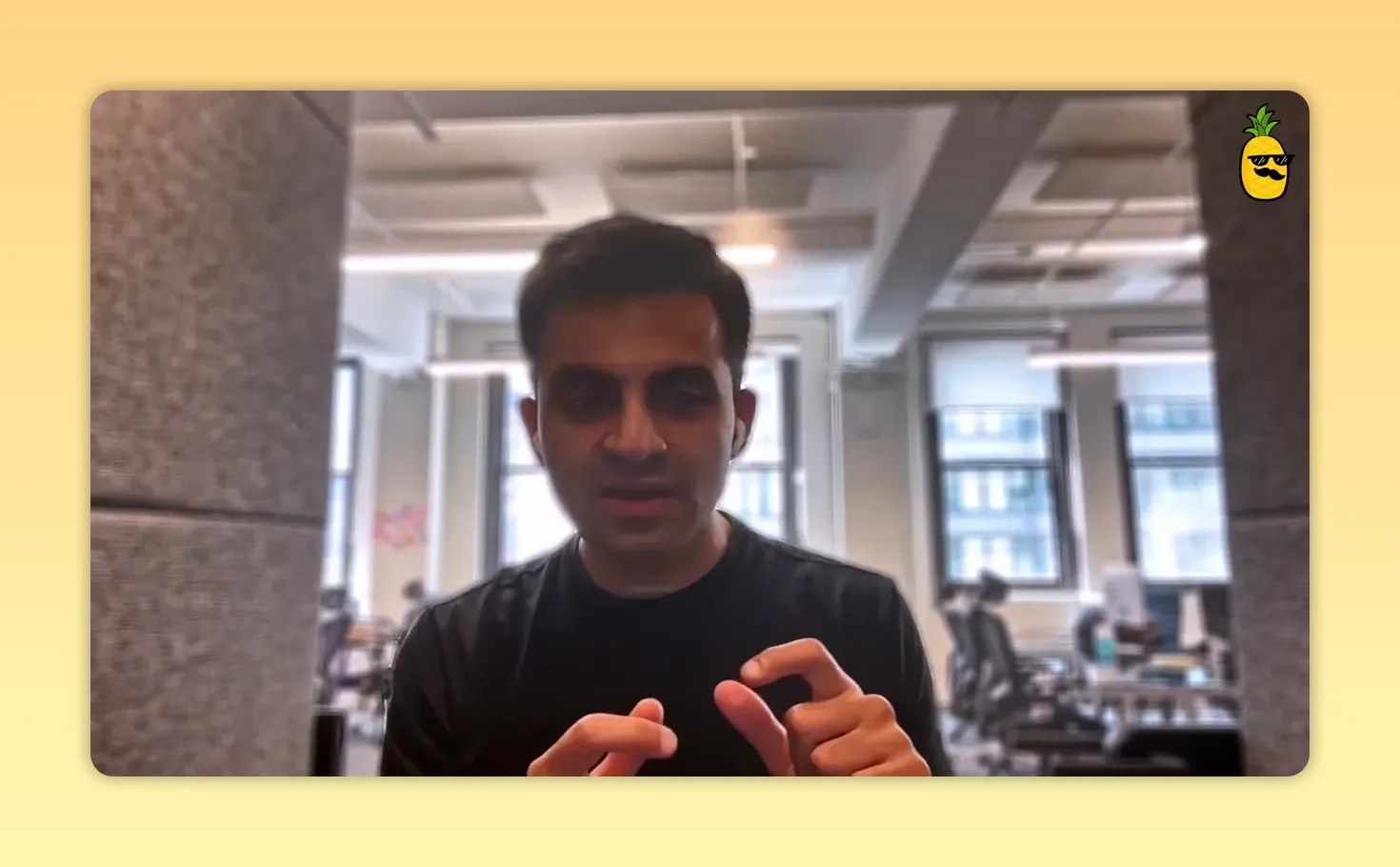 Founder in an office using small pinch hand gestures to emphasize a messaging point
