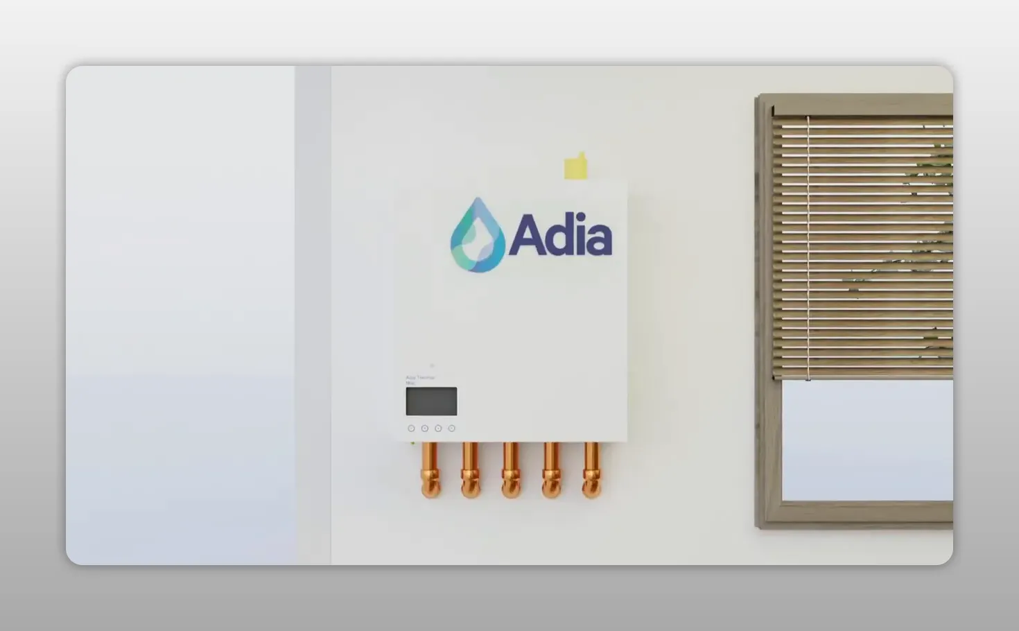 White Adia smart heating control hub mounted beside a window