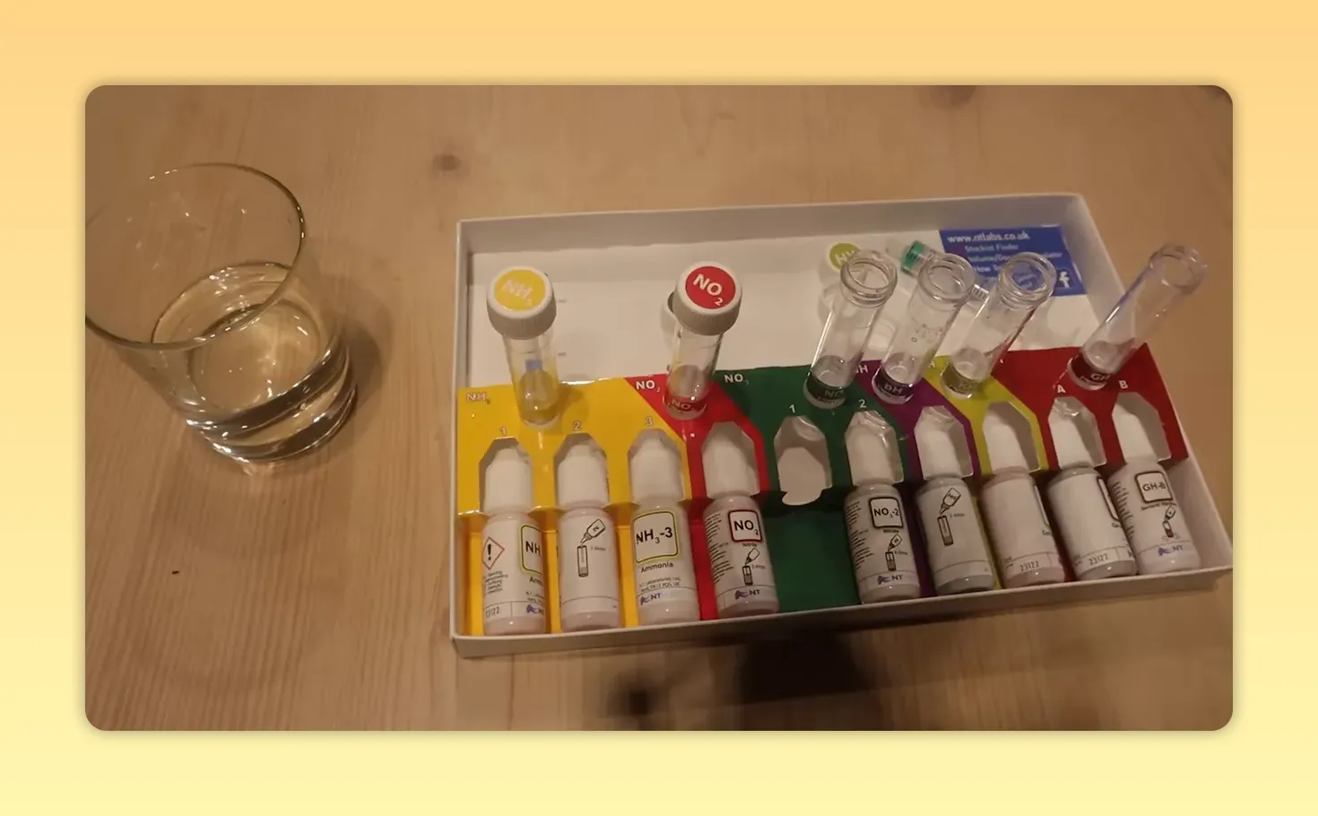 Aquarium water test kit with coloured reagent bottles and glass test tubes
