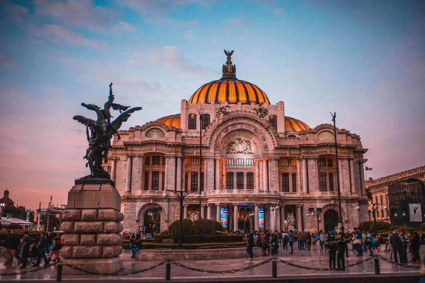 People standing in front of the Palacio de Bellas Artes in Mexico City.