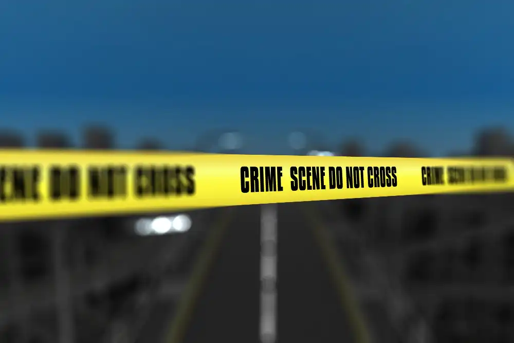 Photo of a crime scene tape against blurred city background