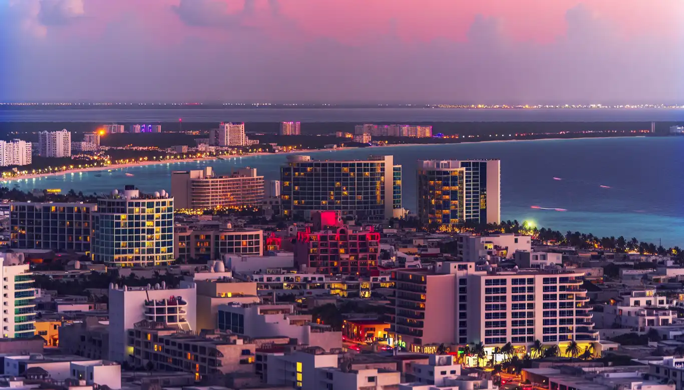 Cancun cityscape at dusk with the ocean in the background