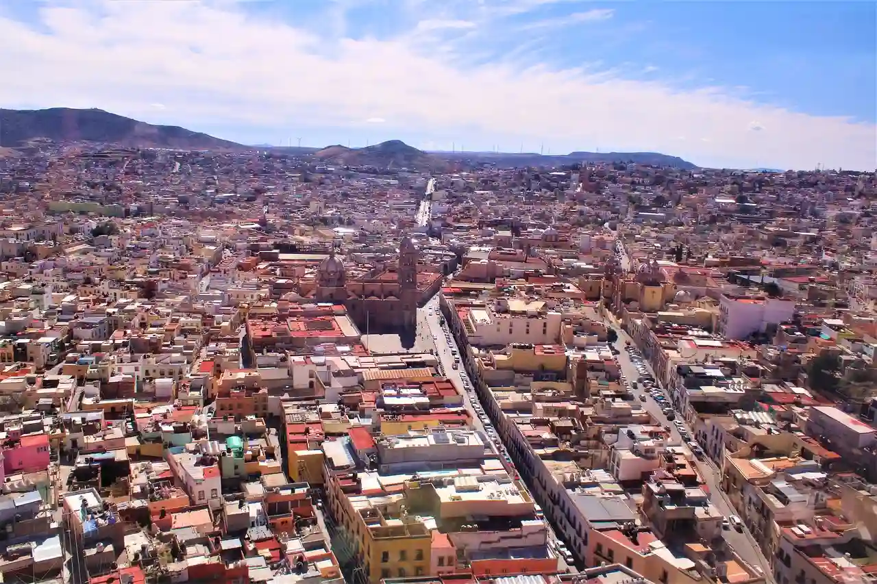 Bird's-eye view photograph of Zacatecas during daytime, showcasing the city's unique layout and architectural landmarks