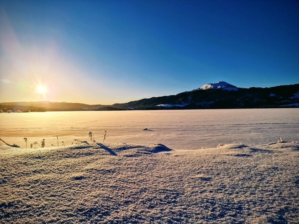 May be an image of lake, twilight, ski slope, nature and arctic