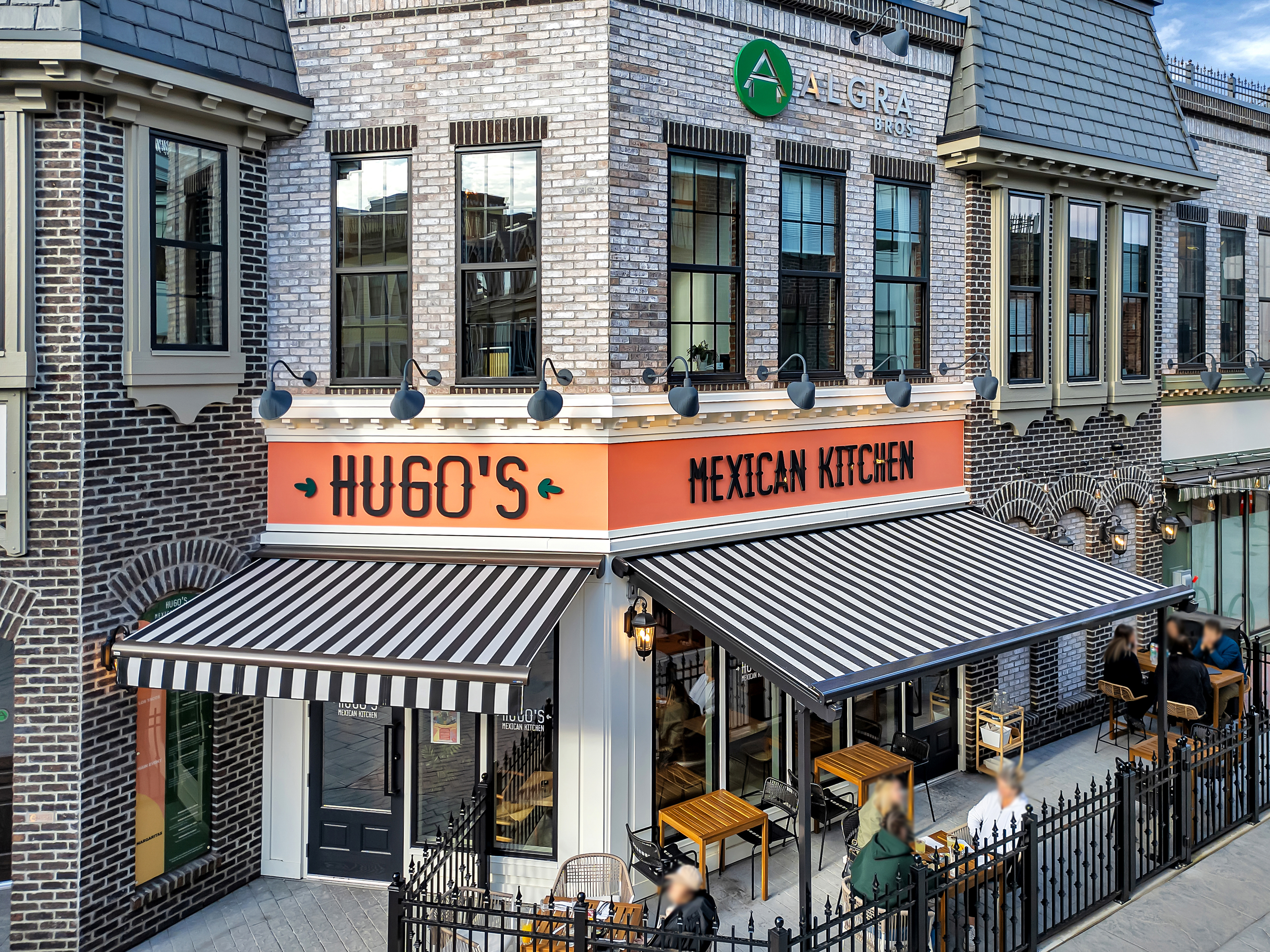 Striped black and white awnings in busy city setting