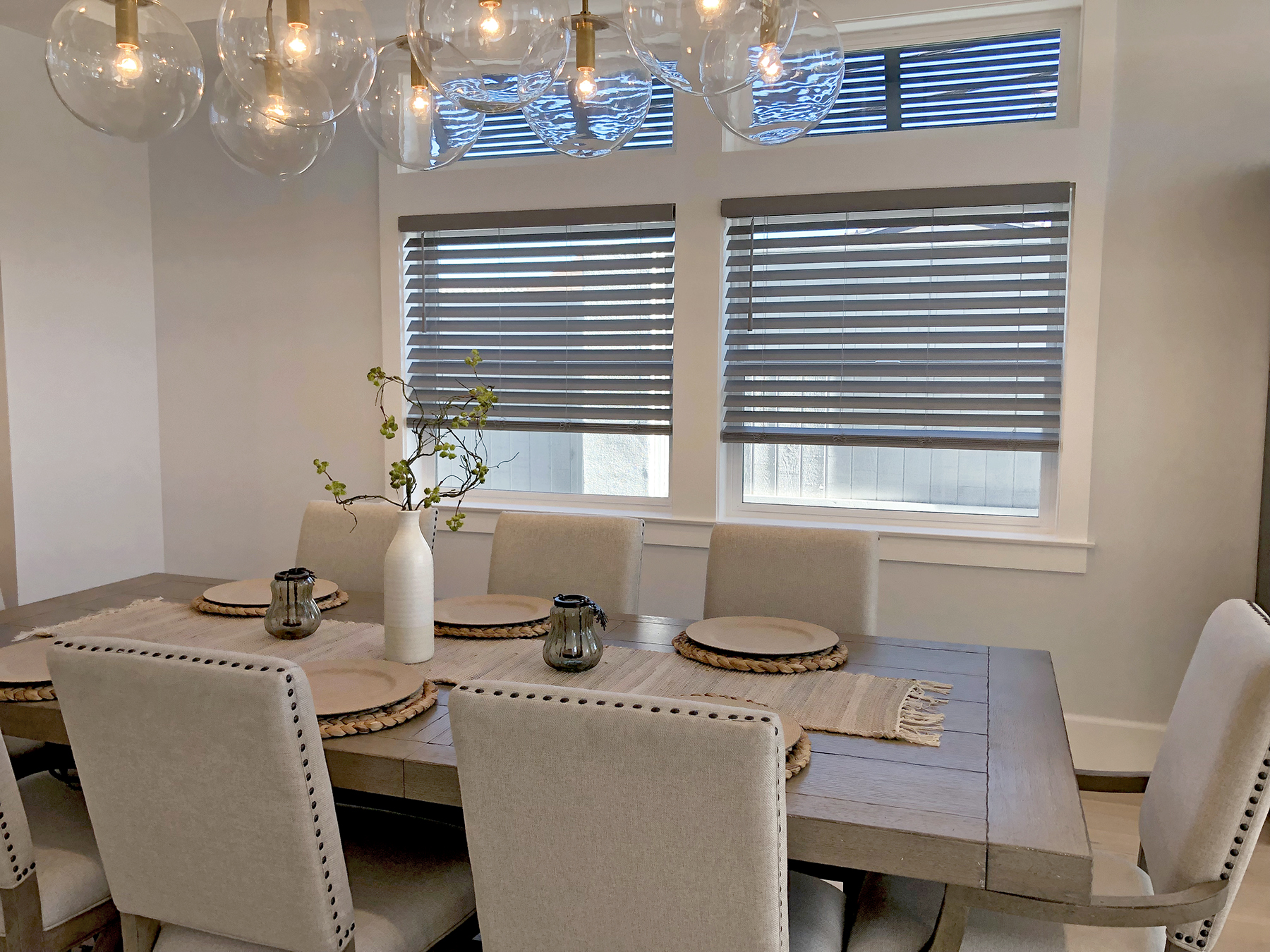 Dining room with cordless faux wood blinds in 100 Mile House