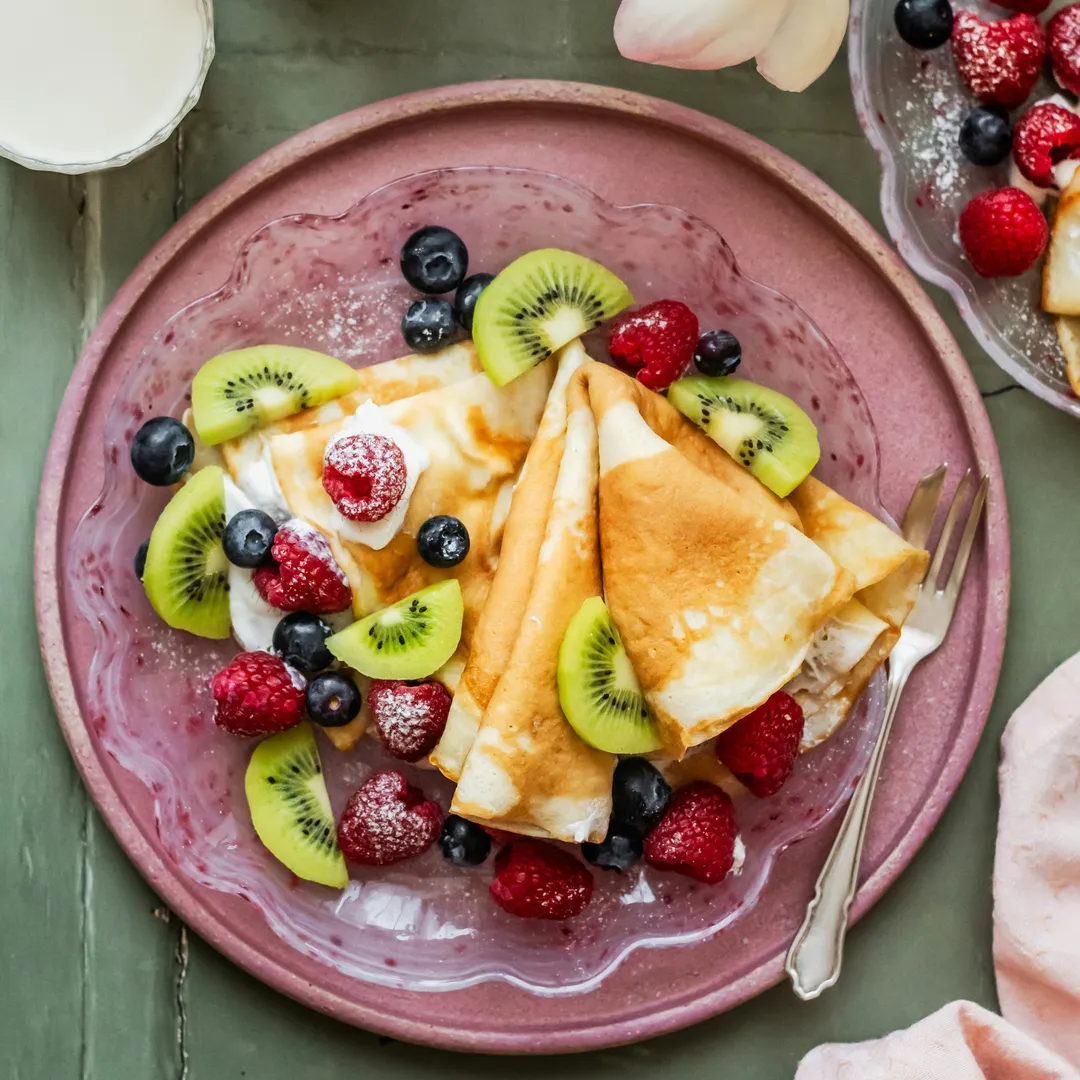 des crêpes garnies de fruit sur une assiette